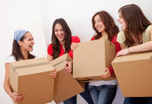 Movers using PPE and careful handling to protect a property during loading